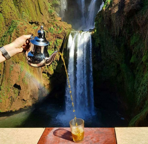 Ouzoud Waterfalls cascading down rocky cliffs surrounded by lush greenery near Marrakech, Morocco
