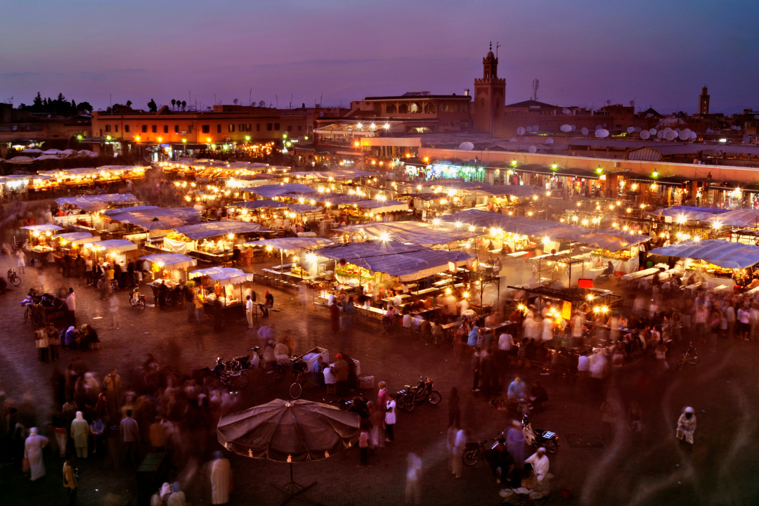 Jemaa el-Fna square at sunset with food stalls and crowds in Marrakech Morocco