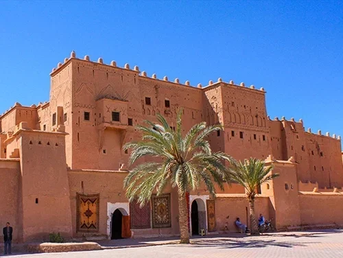 Panoramic view of the Kasbah Taourirt in Ouarzazate, Morocco, with traditional Berber architecture and desert backdrop
