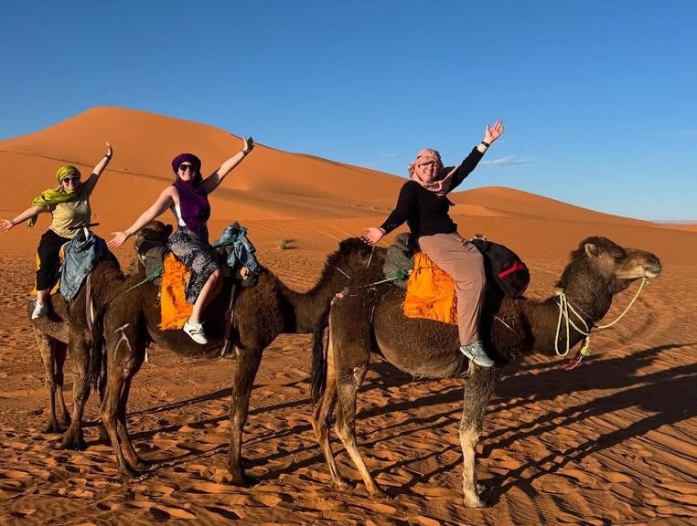 Camel trekking Sunset over the dunes of the Merzouga desert in Morocco